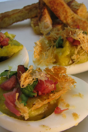 Mexican devilled eggs with avocado, chorizo, cilantro and cheese crisps